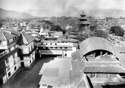 A view from atop Basantapur Durbar over Nasal Chowk towards the north, in the 1920s. The Kirtipur tower in the foreground was built in the 18th century; its roof is in the Bengali style. Source: Images of the Century