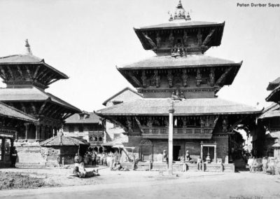 Bhimsen Temple on the northern rim of Patan Durbar Square. Built by King Shrinivas Malla in the early 1680s, it features exquisite carvings that still remain Photographed by Colin Murray 1870AD